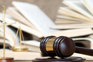 A gavel resting on a desk.